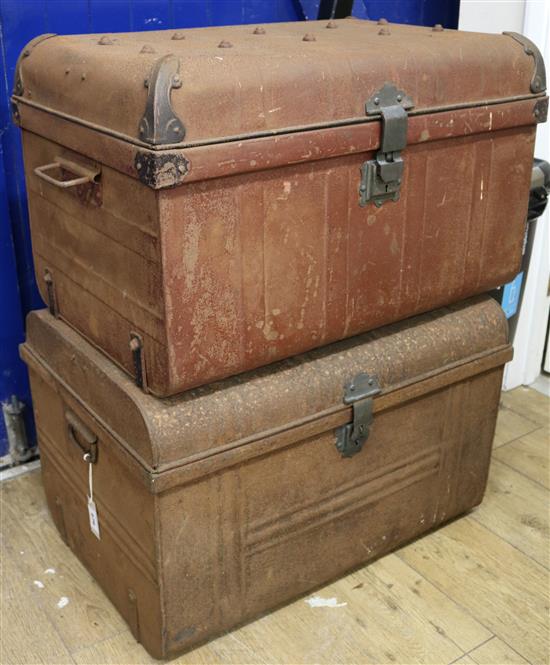 A pair of metal travelling trunks